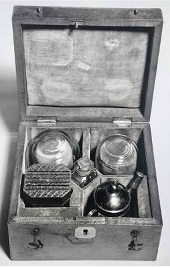 A wooden cupping box lined with velvet and including a brass spirit lamp. Made by Savigny of London, late 18th to early 19th century. Medical almanacs advertised a variety of different models of cupping boxes. The top of the range was made of finely polished mahogany or rosewood and lined with red felt or velvet. Each box usually contained two or three glass cups, a spring scarificator to incise the skin for wet cupping, a jar of smelling salts (to revive the patient if required) and either a brass lamp or a cupping torch.